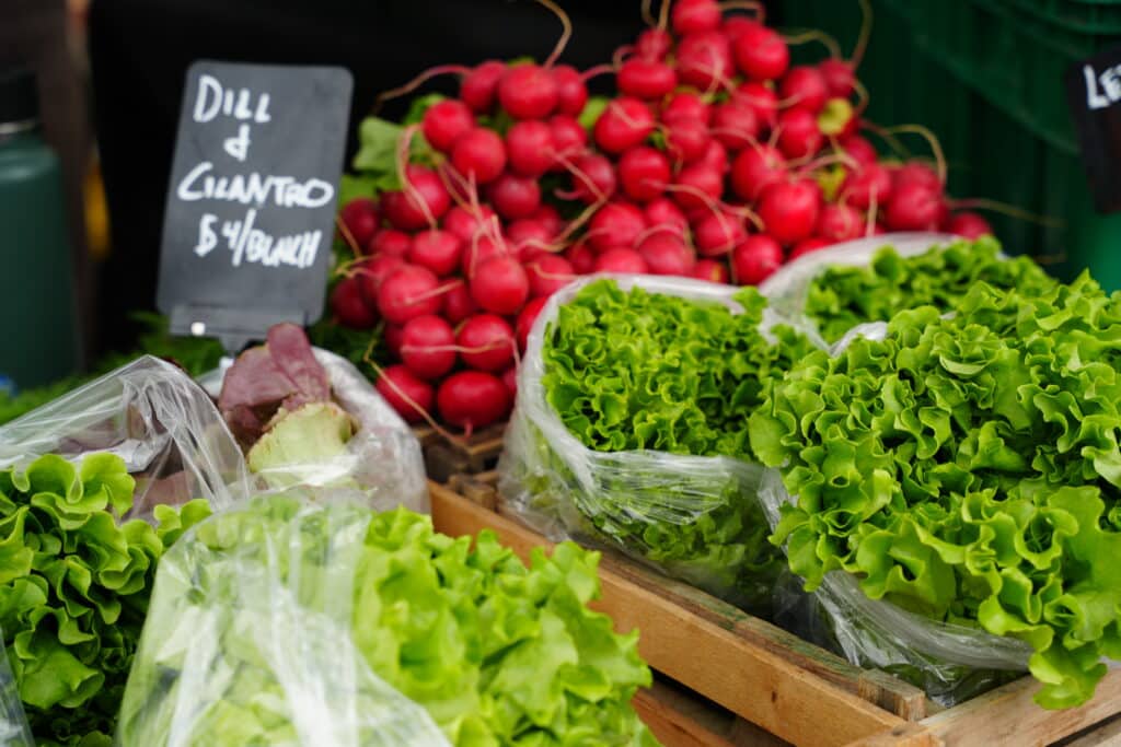 Herbs, lettuce and radishes laid out at a Farmer's Market
