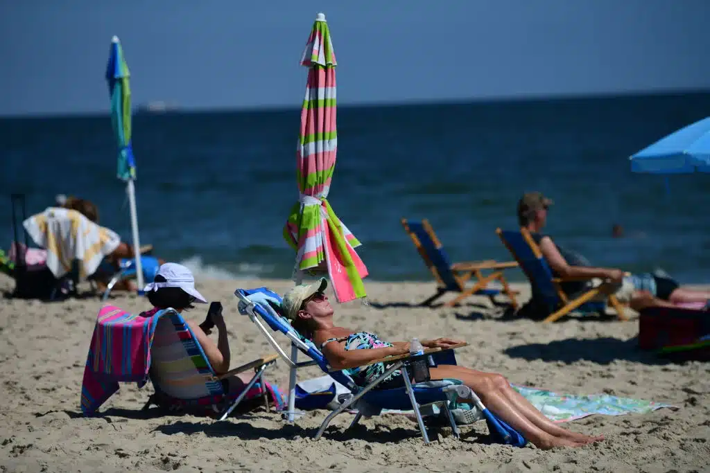 Beach goers sunbathe at Rehoboth Beach on September 20, 2022 in Rehoboth Beach, Delaware.