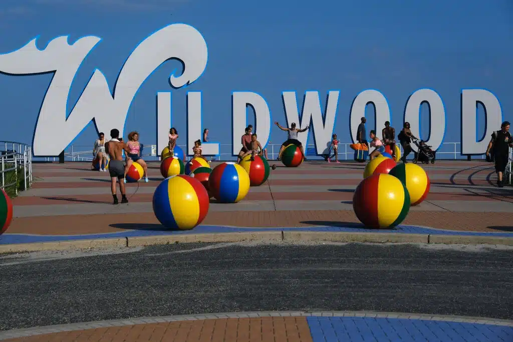 People walk along the boardwalk days before the Memorial Day weekend, the un-official start of summer, on the Jersey shore on May 27, 2021 in Wildwood, New Jersey. Wildwood,