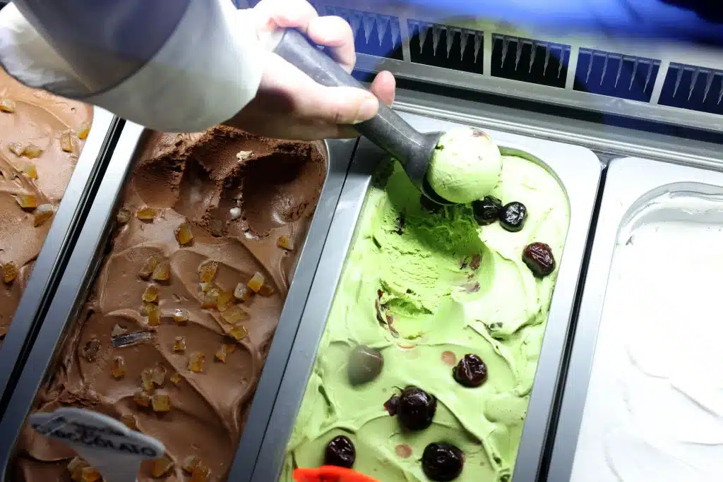 an ice cream sundae man scooping ice cream