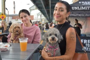 Fishtown Beer Festival. Two girls and their dogs having a beer.